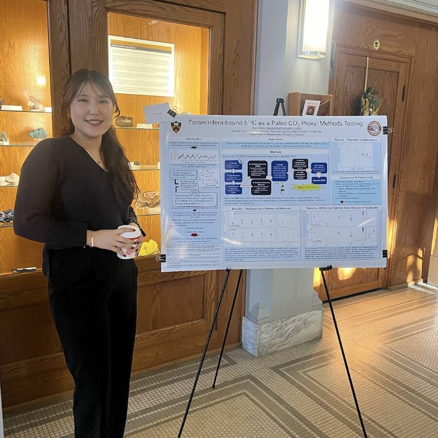 A student presenting her junior work as a poster presentation.